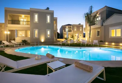 a swimming pool in front of a house at Limosa Luxury Residences in Kissamos