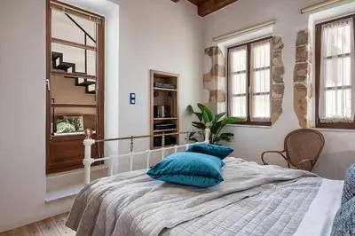 a bedroom with a bed with blue pillows on it at Agazade Bey in Chania Town