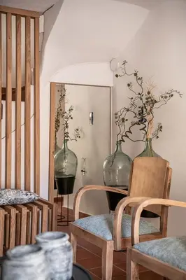 two glass vases sitting on a table with two chairs at Agazade Bey in Chania Town