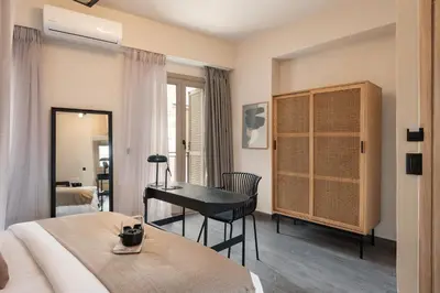 a bedroom with a desk and a bed and a desk at Anaem Eclectic Rooms in Chania Town