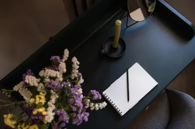 a black desk with flowers and a clock on it at Anaem Eclectic Rooms in Chania Town