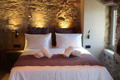 a bedroom with a bed with two towels on it at INO II Domus POOL by Amigdalokefali Elafonissi in AmigdhalokeFálion