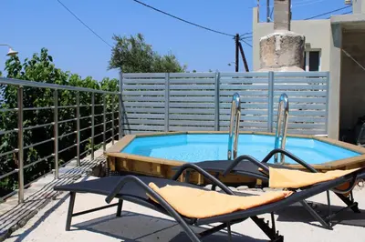 a patio with two chairs and a swimming pool at INO II Domus POOL by Amigdalokefali Elafonissi in AmigdhalokeFálion