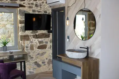 a bathroom with a sink and a mirror at INO II Domus POOL by Amigdalokefali Elafonissi in AmigdhalokeFálion