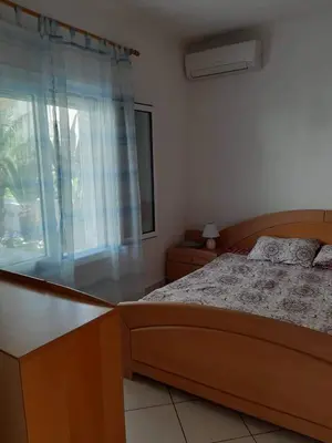 a bedroom with a bed and a window at Alexandros cosy house for family vacation in Chania Town