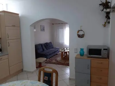 a kitchen and a living room with a blue couch at Alexandros cosy house for family vacation in Chania Town