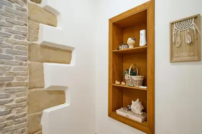 a book shelf next to a staircase in a room at Semeli Apartment in Kissamos