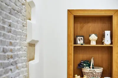 a wooden shelf in a room with a plant at Semeli Apartment in Kissamos