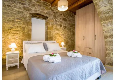 a bedroom with a bed with towels on it at Villa Arietta in Kharkhalianá