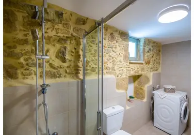 a bathroom with a shower and a toilet at Villa Arietta in Kharkhalianá