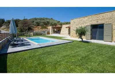 a yard with a swimming pool and a house at Villa Arietta in Kharkhalianá