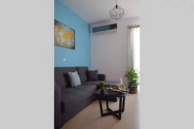 a living room with a couch and a table at Vitro art House-in the heart of Chania in Chania Town