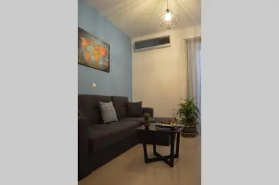 a living room with a couch and a table at Vitro art House-in the heart of Chania in Chania Town