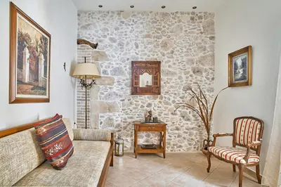 a living room with a stone wall at Ekavi Apartment in Kissamos