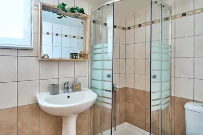 a bathroom with a sink and a shower at Ekavi Apartment in Kissamos