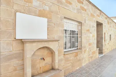 a blank billboard on the side of a brick building at Ekavi Apartment in Kissamos