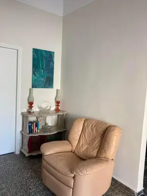 a brown leather chair sitting in a room at Reina House in Chania Town