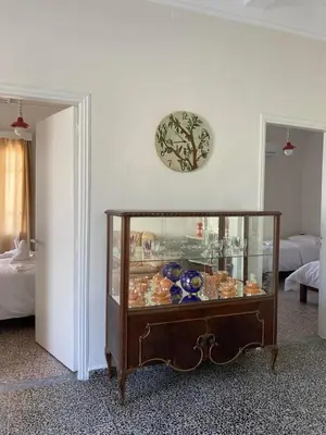a room with a glass cabinet filled with dishes at Reina House in Chania Town