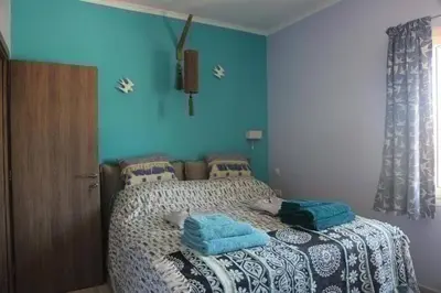 a bedroom with a bed with blue walls at Casa Anthos free parking in Chania Town