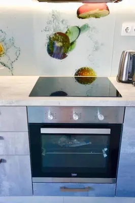 a kitchen counter with an oven with vegetables on it at Casa Anthos free parking in Chania Town