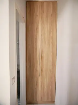 a wooden cabinet in the corner of a room at Erotokritos Studios near the beach in Agia Marina Nea Kydonias