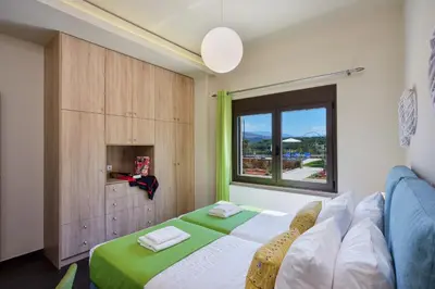 a bedroom with a bed and a window at Villa Abelizia in Chania Town