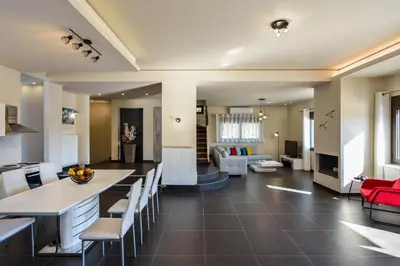 a kitchen and living room with a red couch at Villa Abelizia in Chania Town