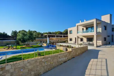 a villa with a swimming pool and a house at Villa Abelizia in Chania Town