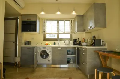 a kitchen with a washer and a washing machine at Filia Luxury Apartments in Chania Town