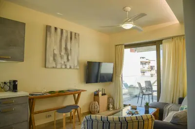 a living room with a couch and a tv on the wall at Filia Luxury Apartments in Chania Town