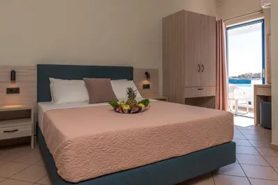 a bedroom with a bed with a bowl of fruit on it at Libyan Sunrise in Palaiochóra