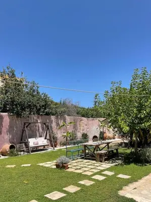 a garden with a picnic table and a bench at Maria`s Peaceful Nest in Chania Town
