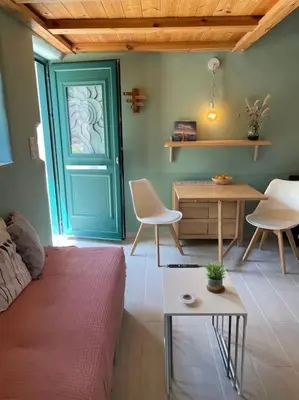 a room with a blue door and a table and chairs at Maria`s Peaceful Nest in Chania Town