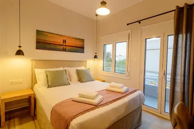 a bedroom with a bed with two towels on it at Bitsakis Family II - Paleochora Luxury House in Palaiochóra