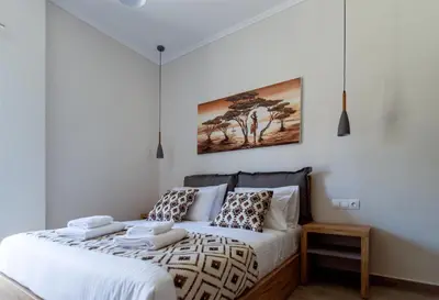 a bedroom with a bed with white sheets and pillows at Bitsakis Family II - Paleochora Luxury House in Palaiochóra