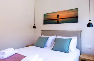 a bedroom with a bed and a painting on the wall at Bitsakis Family II - Paleochora Luxury House in Palaiochóra