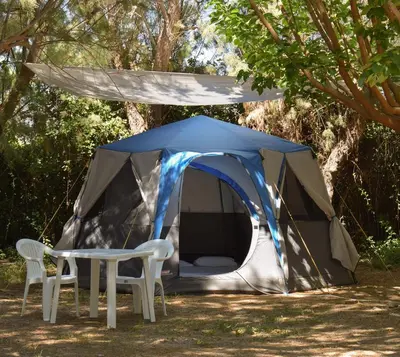 a tent with two chairs and a table in front of it at Camping Mithimna in Kissamos