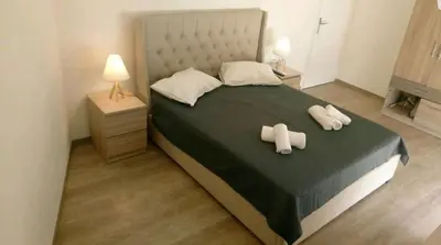 a bedroom with a large bed with two pillows at Penthouse Apartment in Chania Heart in Chania Town