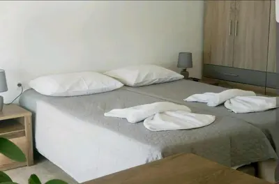 a bed with two white towels on top of it at Penthouse Apartment in Chania Heart in Chania Town