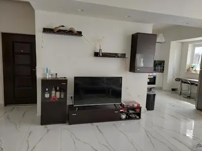 a living room with a flat screen tv on a wall at Penthouse Apartment in Chania Heart in Chania Town