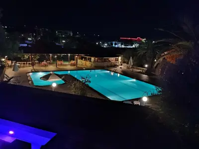 a view of a pool at night at Kyriaki Hotel in Kato Daratso