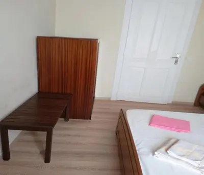 a bedroom with a bed and a table and a door at Kissamos Grandfather's House in Kissamos