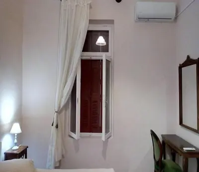 a room with a window and a desk and a table at Kissamos Grandfather's House in Kissamos