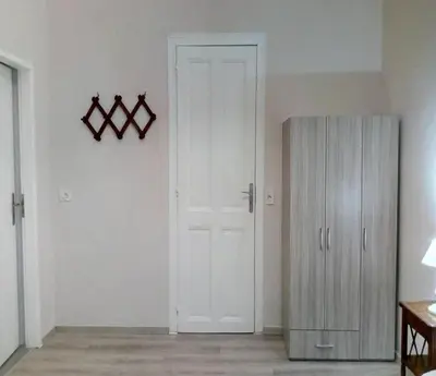 a room with a white door and a cabinet at Kissamos Grandfather's House in Kissamos