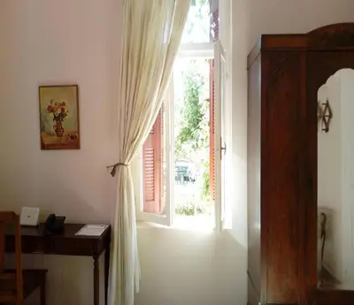 a room with a window and a desk and a door at Kissamos Grandfather's House in Kissamos