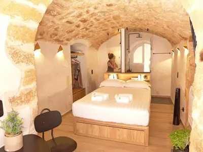 a bedroom in a cave with a bed in it at Eva Plus in Chania Town