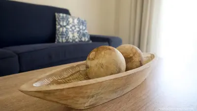 a wooden bowl on top of a wooden table at Alexandra SeaSide Villas in Plataniás