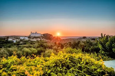 a view of a house with the sunset in the background at Iliovasilema Apartments in Elafonisi