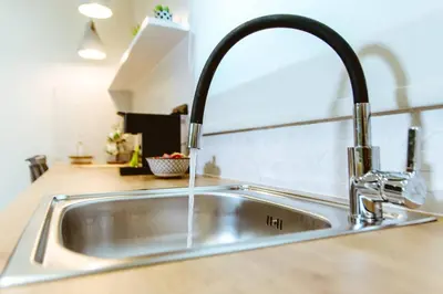 a kitchen sink with a faucet in a kitchen at Iliovasilema Apartments in Elafonisi