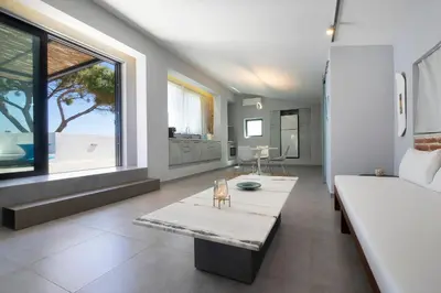 a bedroom with a large bed and a large window at Cretan Loft in Plataniás